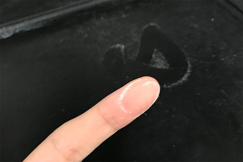 A person's finger showing powder from a hood