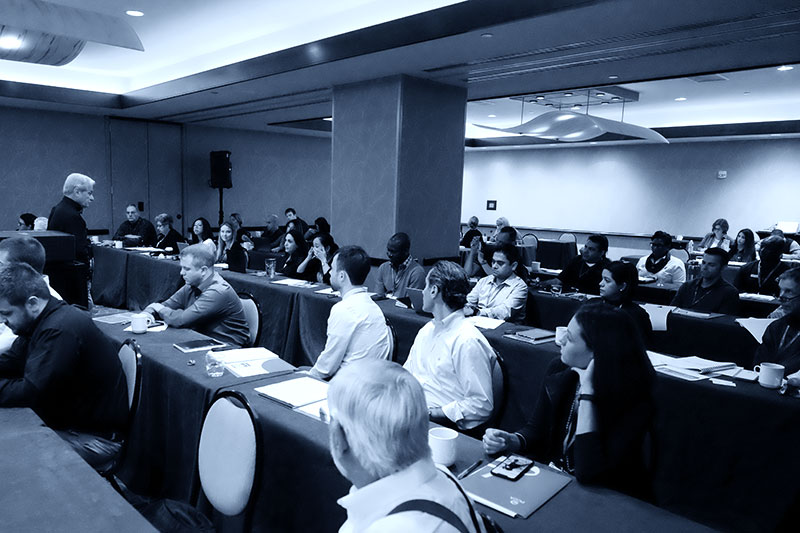 Ross Caputo presenting in front of mixed audience during a seminar
