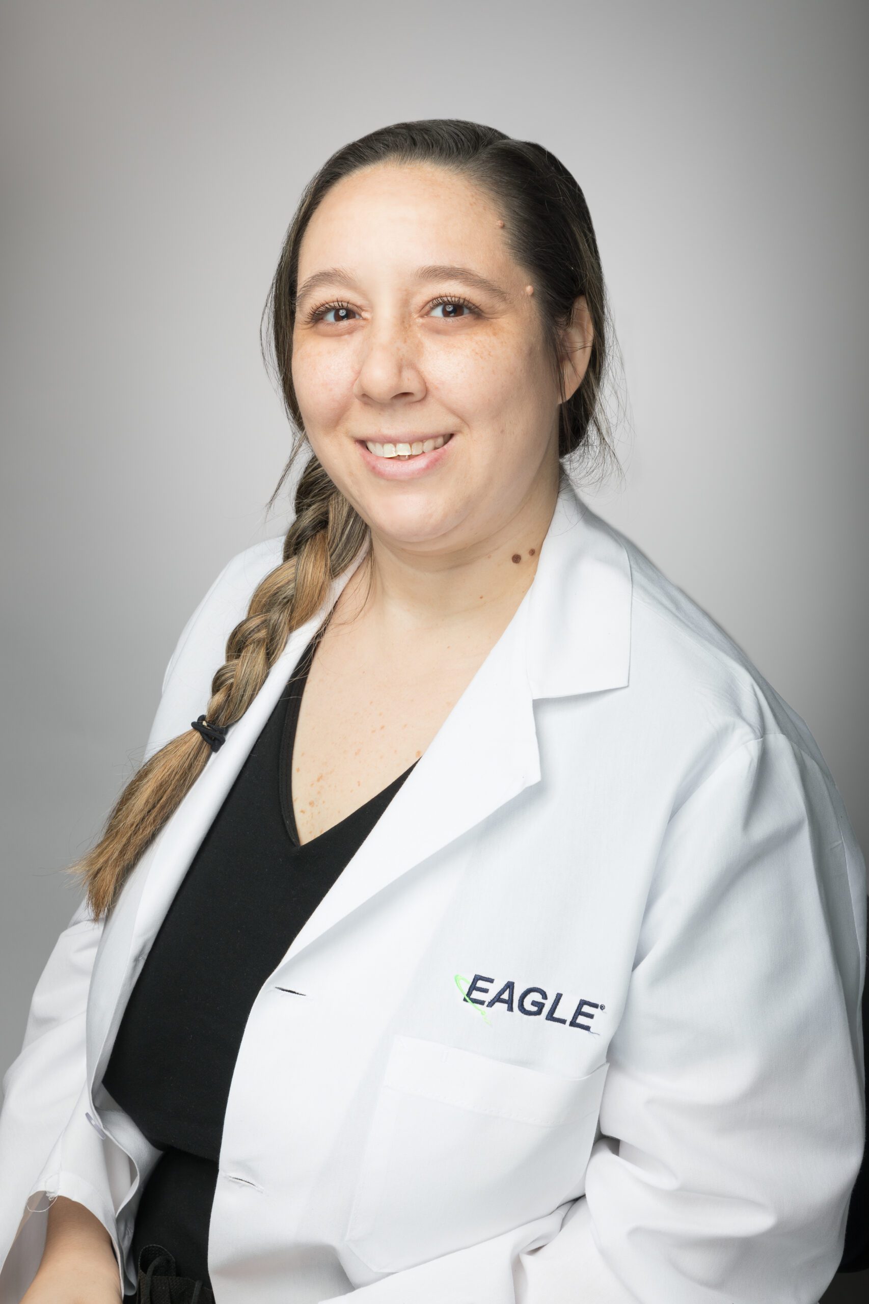 Microbiology Manager Ashley Trueheart smiles while wearing an Eagle lab coat.