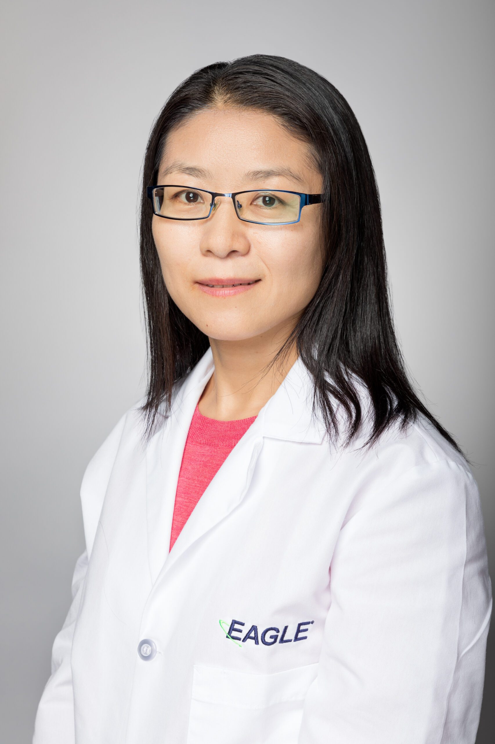 Research and Development Supervisor Jenny Wang smiles while wearing an Eagle lab coat.