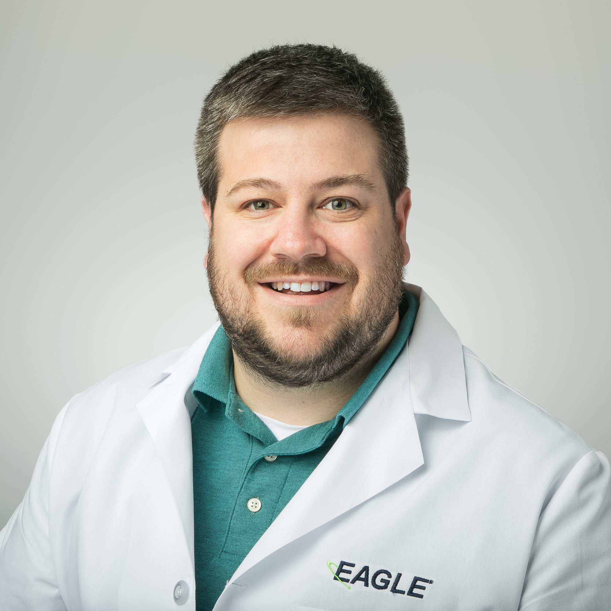 Principal Engineer Jeff Gloyer smiles while wearing a white Eagle lab coat.