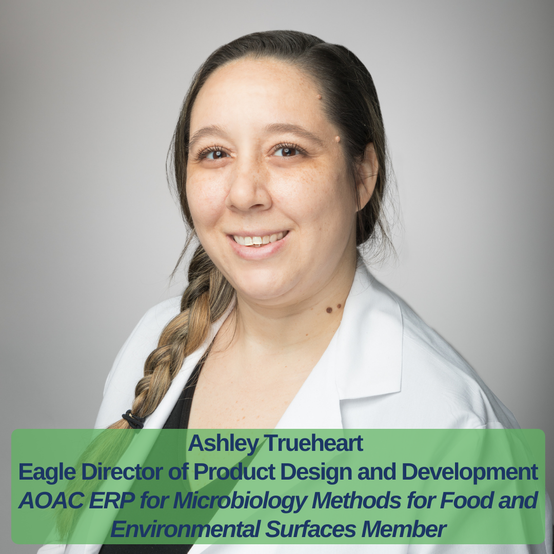 An image of Ashley Trueheart smiling wearing a white Eagle lab coat. Text states, Eagle Director of Product Design & Development selected to become a member of AOAC ERP for Microbiology Methods for Food and Environmental Surfaces
