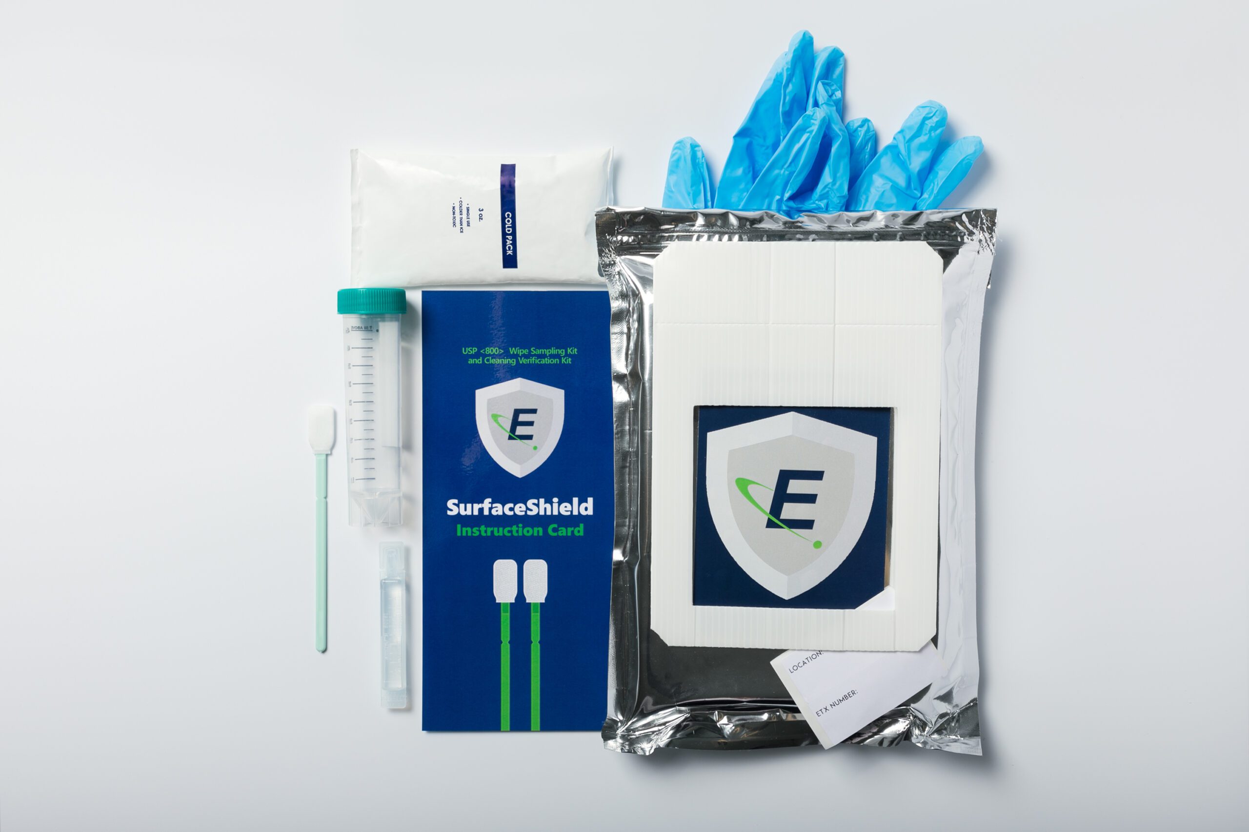 Image of a SurfaceShield Wipe Sampling Kit contents (tube, swab, water, instruction insert, ice pack, template, gloves, & insulated mailer) displayed laying neatly next to each.