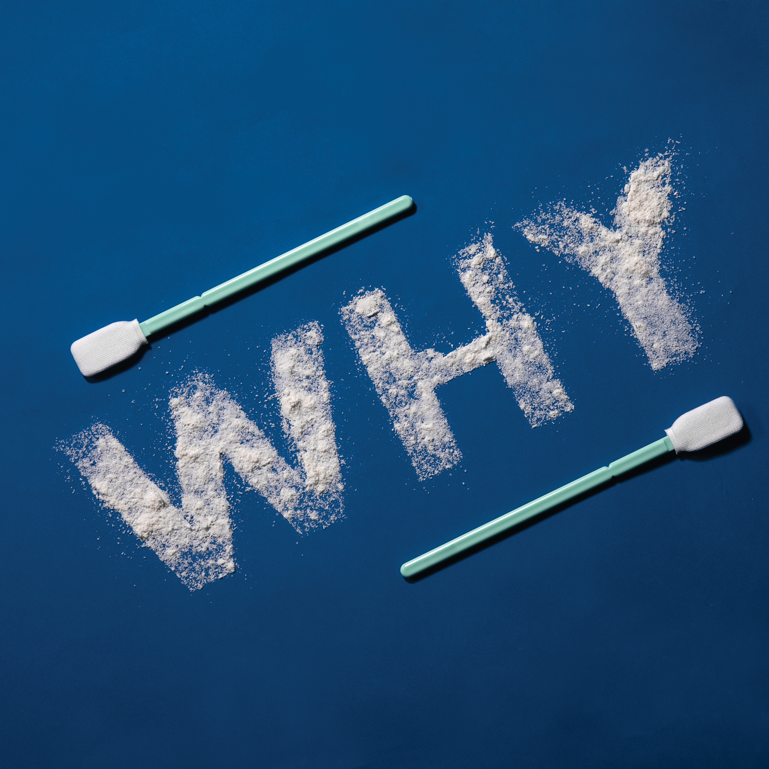 An image of the word "WHY" spelled with white powder with 2 Texwipe® swabs framing it on a blue background.